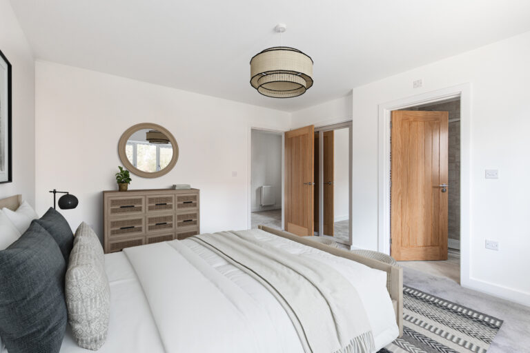 Master bedroom with built in wardrobes and door leading to ensuite.