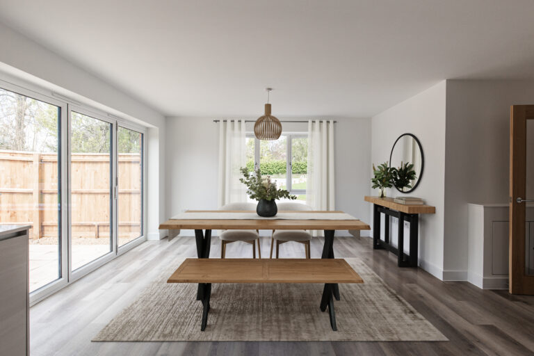Dining area with four seater dining table and bifolding doors leading to garden.
